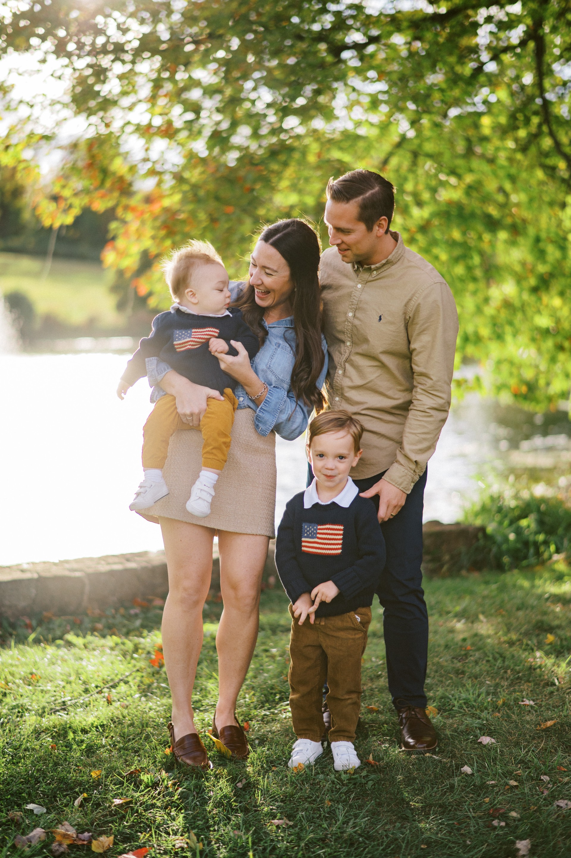 Katie with her husband and two children, smiling outside