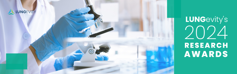 Researcher looking through microscope